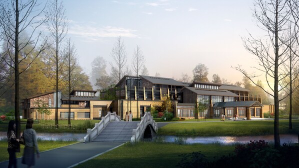A modern building with a stone facade, large windows, and a bridge leading to the entrance. - Holiday Inn Kunshan Huaqiao by IHG (Suzhou)