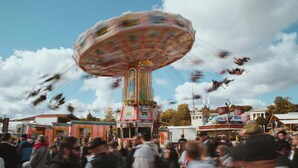 A colorful amusement ride with a crowd around it. - Holiday Inn Express Munich - City East by IHG (Munich)