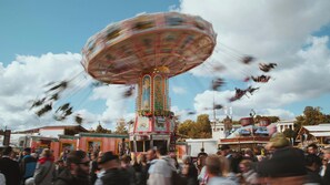 A colorful amusement ride with a crowd around it. - Holiday Inn Express Munich - City East by IHG (Munich)