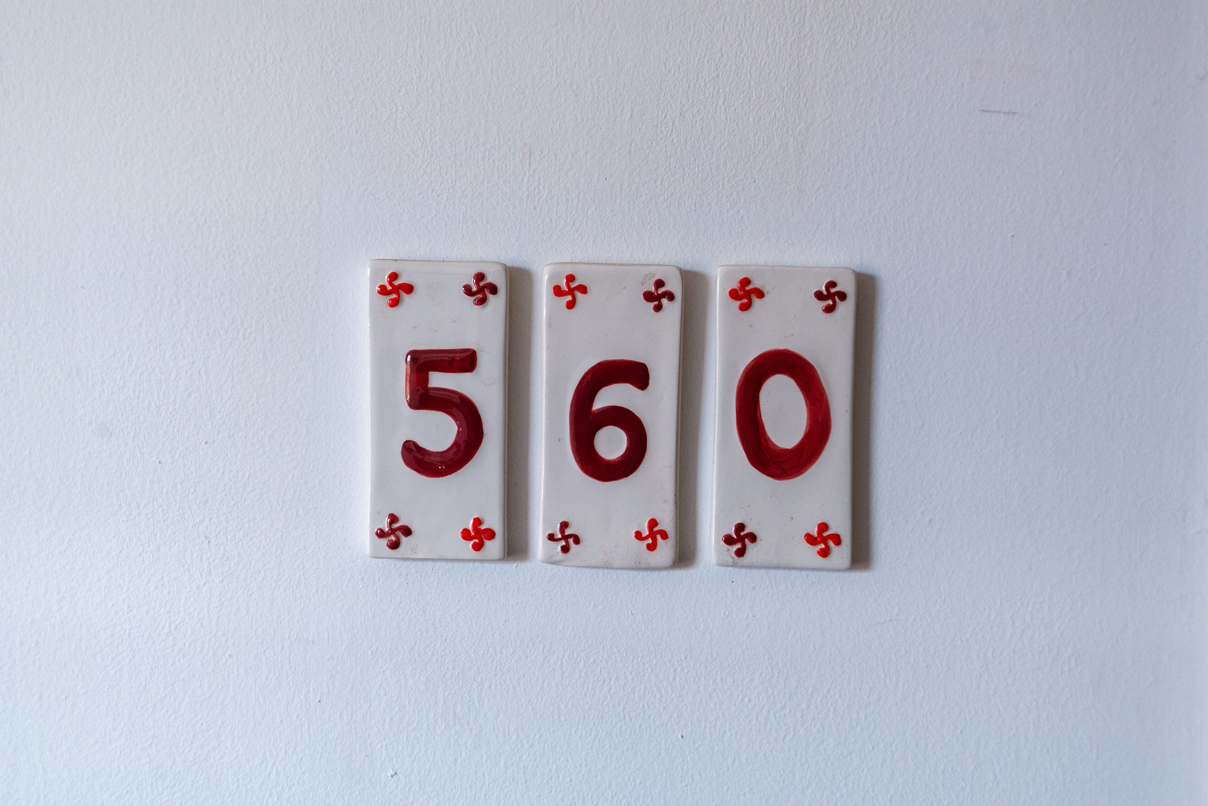 Three playing cards with the numbers 5, 6, and 0.