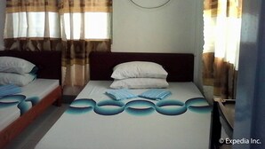 A hotel room with two beds, a window with curtains, an air conditioning unit, and a wall-mounted power outlet. - Tabada Homestay (Mambajao)