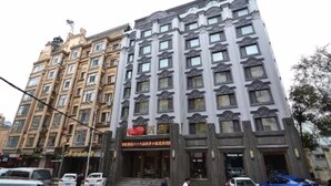 A multi-story hotel with a classic architectural style, featuring ornate window frames and a prominent entrance. - Harbin Yuxuan Hotel (Harbin)