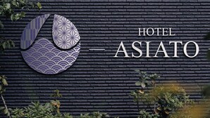 A hotel sign with a stylized logo and the name 'HOTEL ASIATO' on a textured wall. - Hotel ASIATO Namba (Osaka)