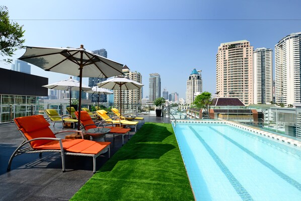 Outdoor pool, a rooftop pool, pool umbrellas