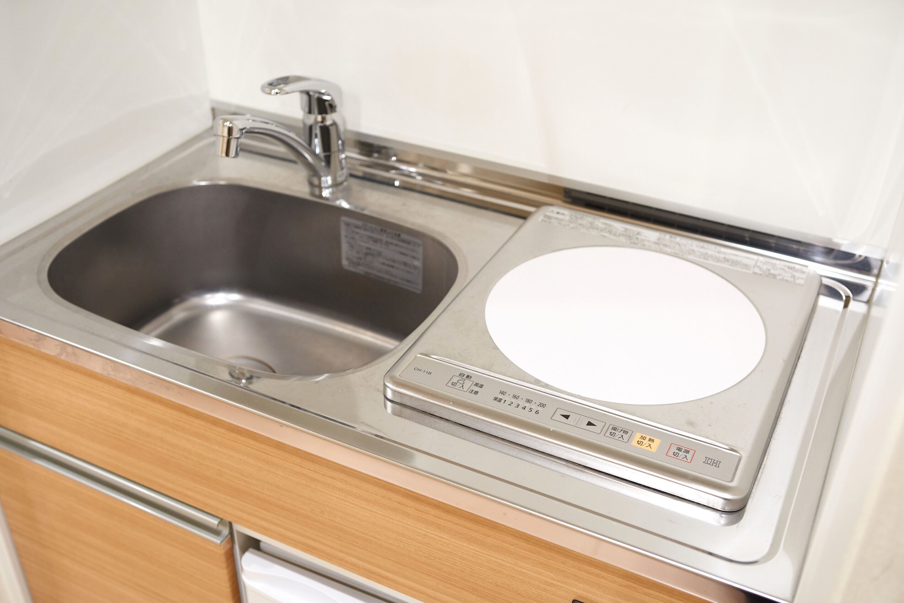 A stainless steel sink with a faucet and a built-in scale.