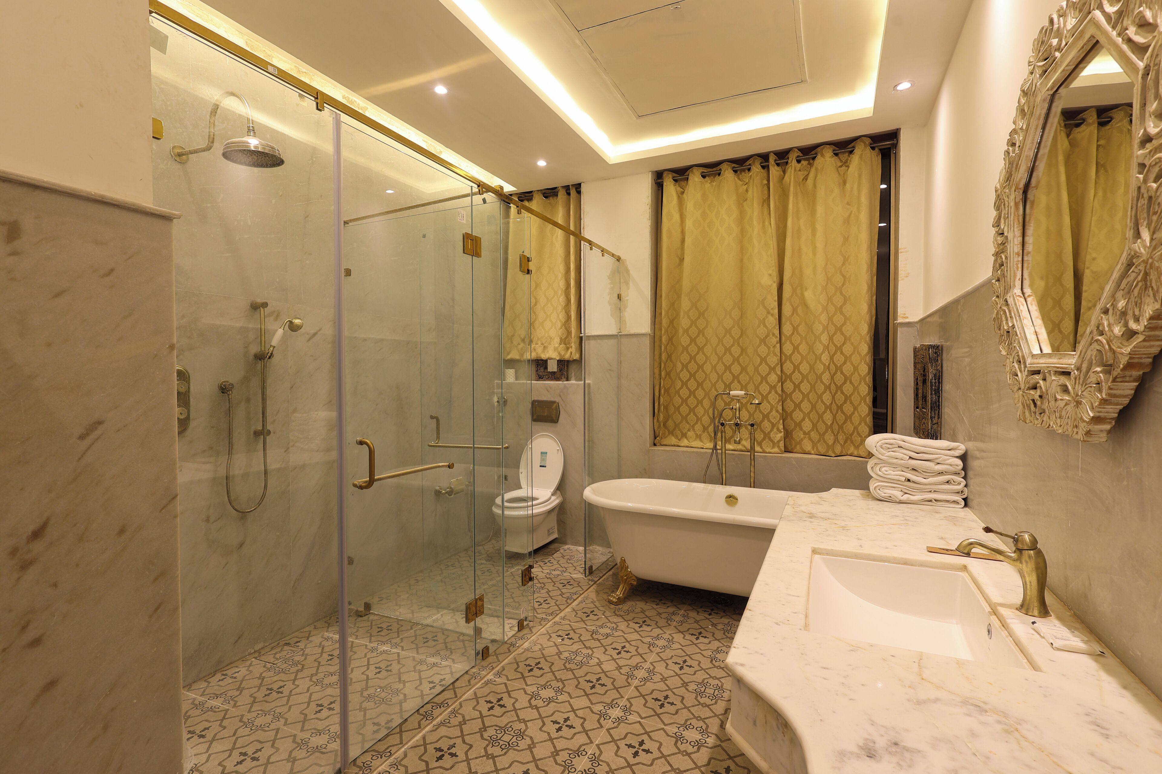 A modern bathroom with a glass-enclosed shower, a freestanding bathtub, and a vanity with a sink.