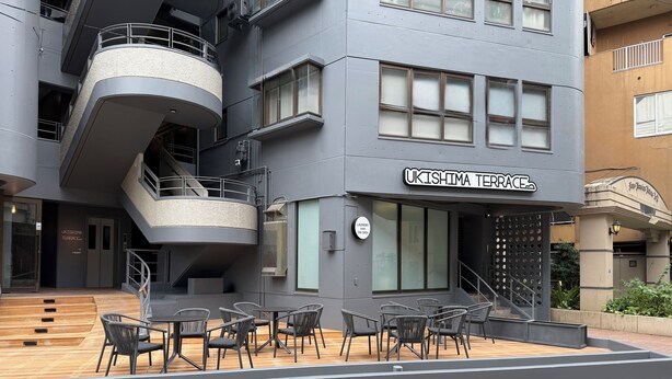 A modern building with a sign reading 'UKISHIMA TERRACE' and a sign indicating laundry services. - Kokusai Towns Inn (Naha)