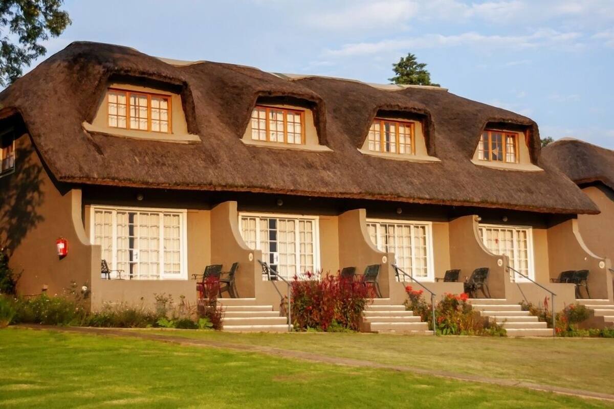 A building with a thatched roof and multiple windows.