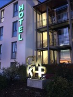 Un edificio de hotel con un letrero que dice "HOTEL" y una gran señal iluminada que dice "GMK".