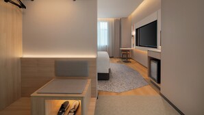 A modern hotel room with a bed, seating area, TV, and a fireplace. - Holiday Inn Express Yiwu International Trade City by IHG (Jinhua)