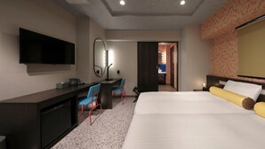 A hotel room with a bed, a desk with chairs, a television, and a mirror. - Nipponbashi LUXE Hotel (Osaka)
