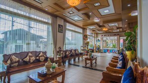 A spacious lobby with a high ceiling, wooden furniture, and large windows. - Royal Inlay Hotel (Nyaungshwe)