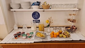 A buffet setup with various food items, condiments, and utensils. - Somerset House (Grange-over-Sands)