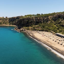 On the beach, black sand, sun-loungers, beach umbrellas