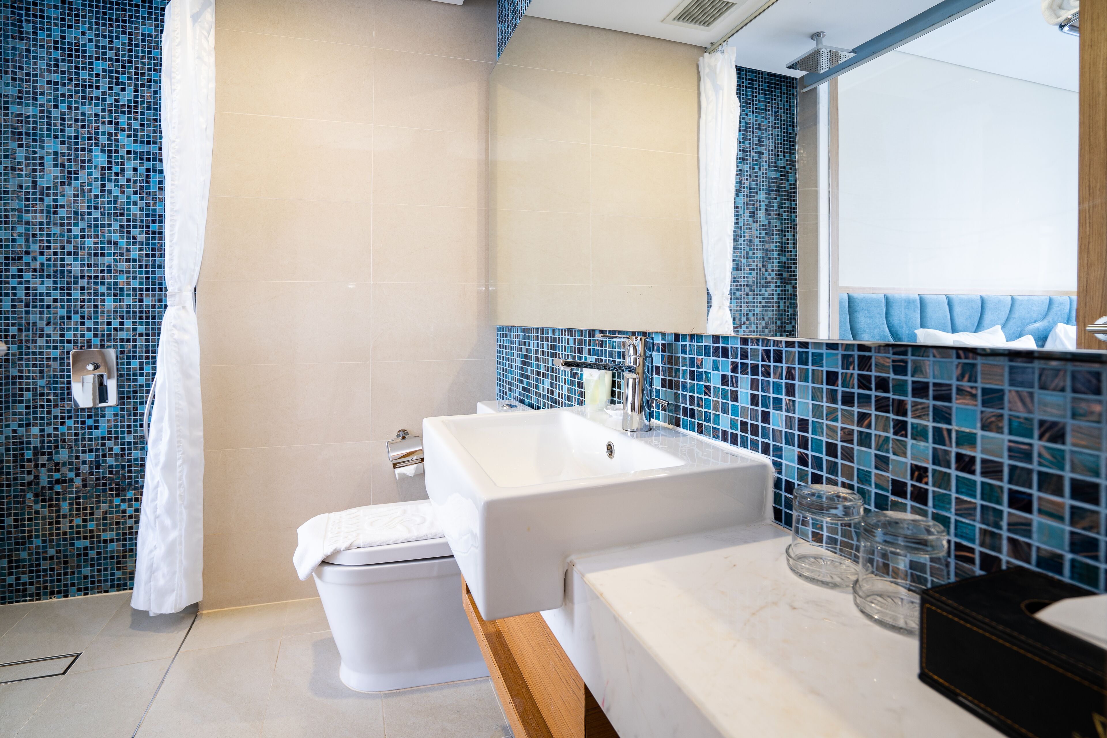 hydromassage showerhead, designer toiletries, hair dryer, slippers