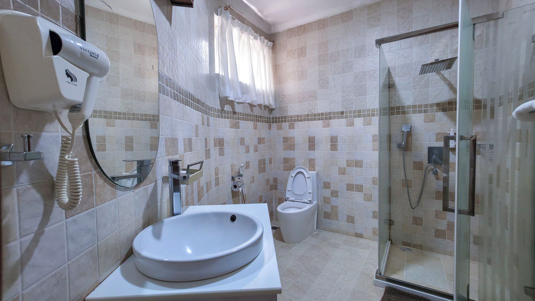 A bathroom with a sink, toilet, and shower.