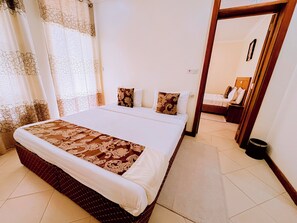 Family Room | Down comforters, minibar, in-room safe, desk - Masailand Safari & Lodge (Arusha)