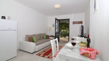 Apartment, 1 Bedroom, Terrace, Partial Sea View | Living area | Flat-screen TV