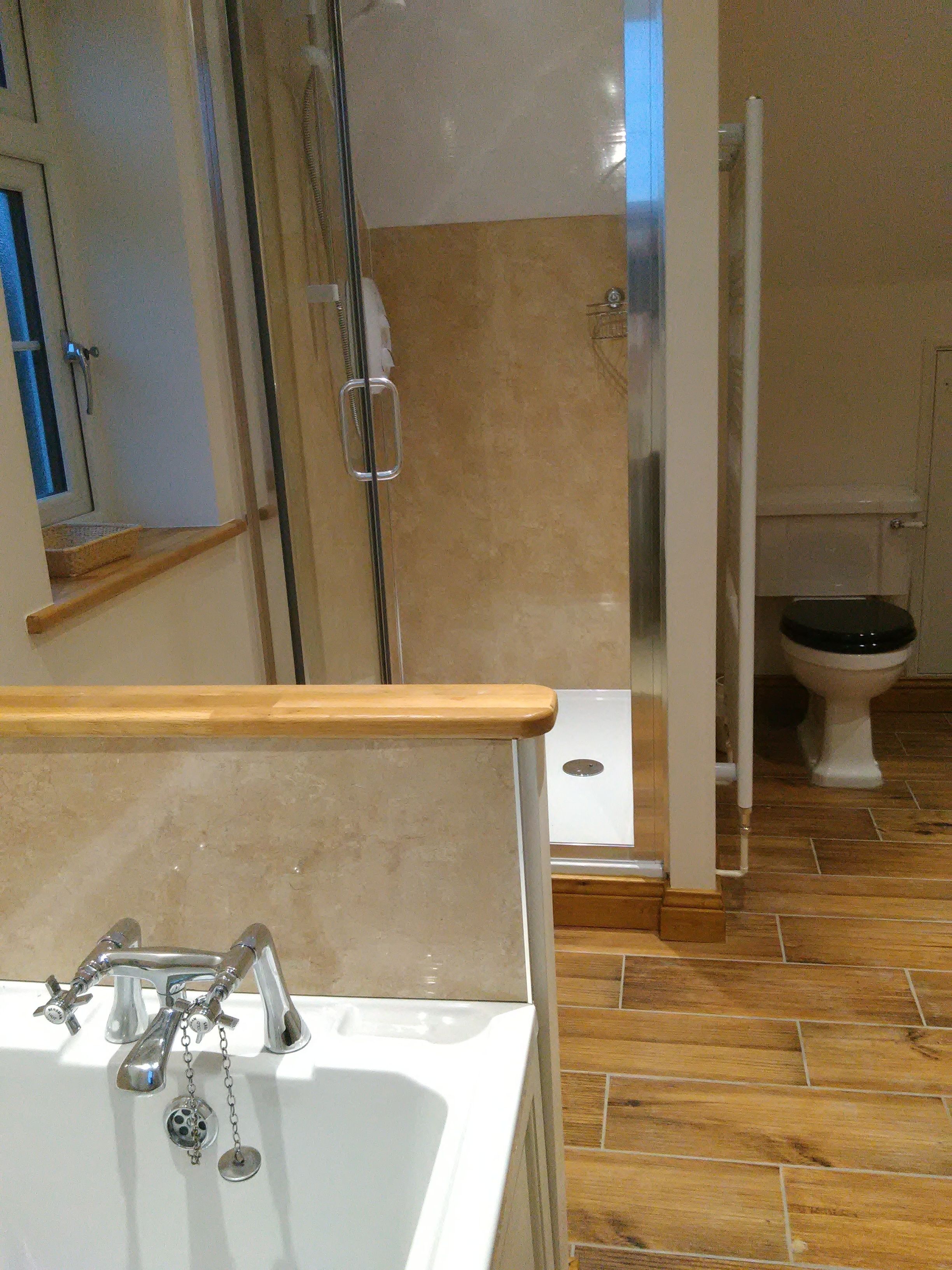 A bathroom with a shower, toilet, and sink.