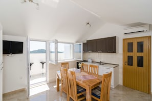Una cocina moderna con comedor, ventanas amplias y vistas al exterior.