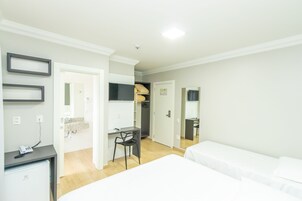 Minibar, escritorio, cortinas blackout y tabla de planchar con plancha 