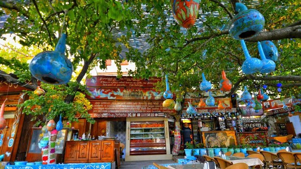 A restaurant with colorful hanging decorations and a sign that reads "Sirincem Restaurant". - Sirincem Pension (Selçuk)
