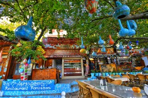 A restaurant with colorful hanging decorations and a sign that reads "Sirincem Restaurant". - Sirincem Pension (Selçuk)
