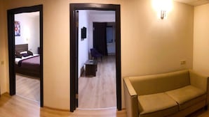 A hotel room with a bed, a small table, a chair, and a sofa. - Non-Stop Hotel (Boryspil)