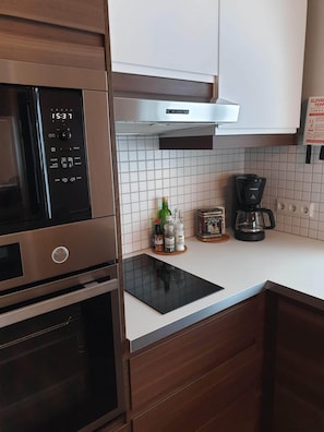 Enjoy cooking in this well-equipped kitchen with a microwave, oven, and induction cooktop.
