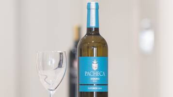 A bottle of Pacheta Douro DOC Superior 2015 wine and a wine glass on a table.