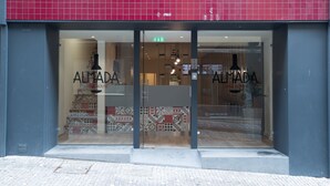 A wine house with a red tiled facade and patterned interior design. - Almada Wine House (Porto)