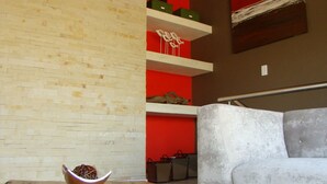 A modern interior with a wooden table, a bowl, and a grey sofa. - BushGlam Luxury Holiday Home (Hoedspruit)