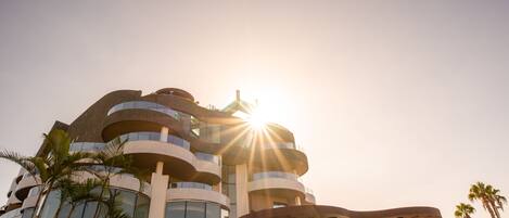 A modern building with multiple balconies and a unique architectural design.