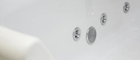 A white bathtub with three chrome fixtures.