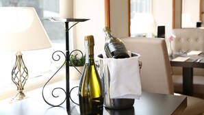 A table with a bottle of wine, a candle, and a glass of water. - Keswick Park Hotel (Keswick)