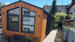 A modern building with large windows and a wooden facade. - Pension Skylark (Pardubice)