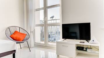City Studio, City View | Living area | Flat-screen TV