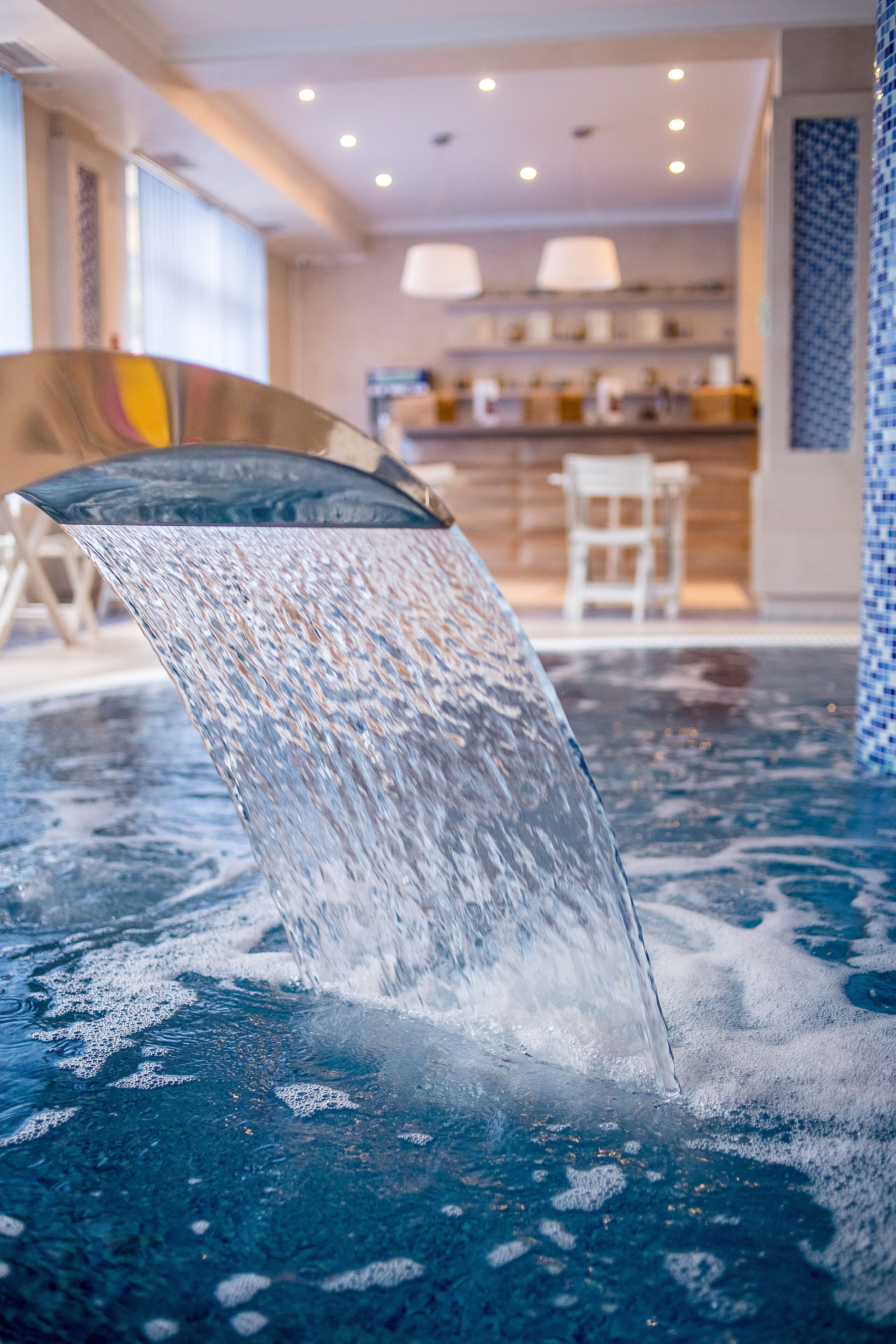A water feature in a hotel lobby with a modern design.