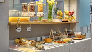 A buffet with various food items and condiments.