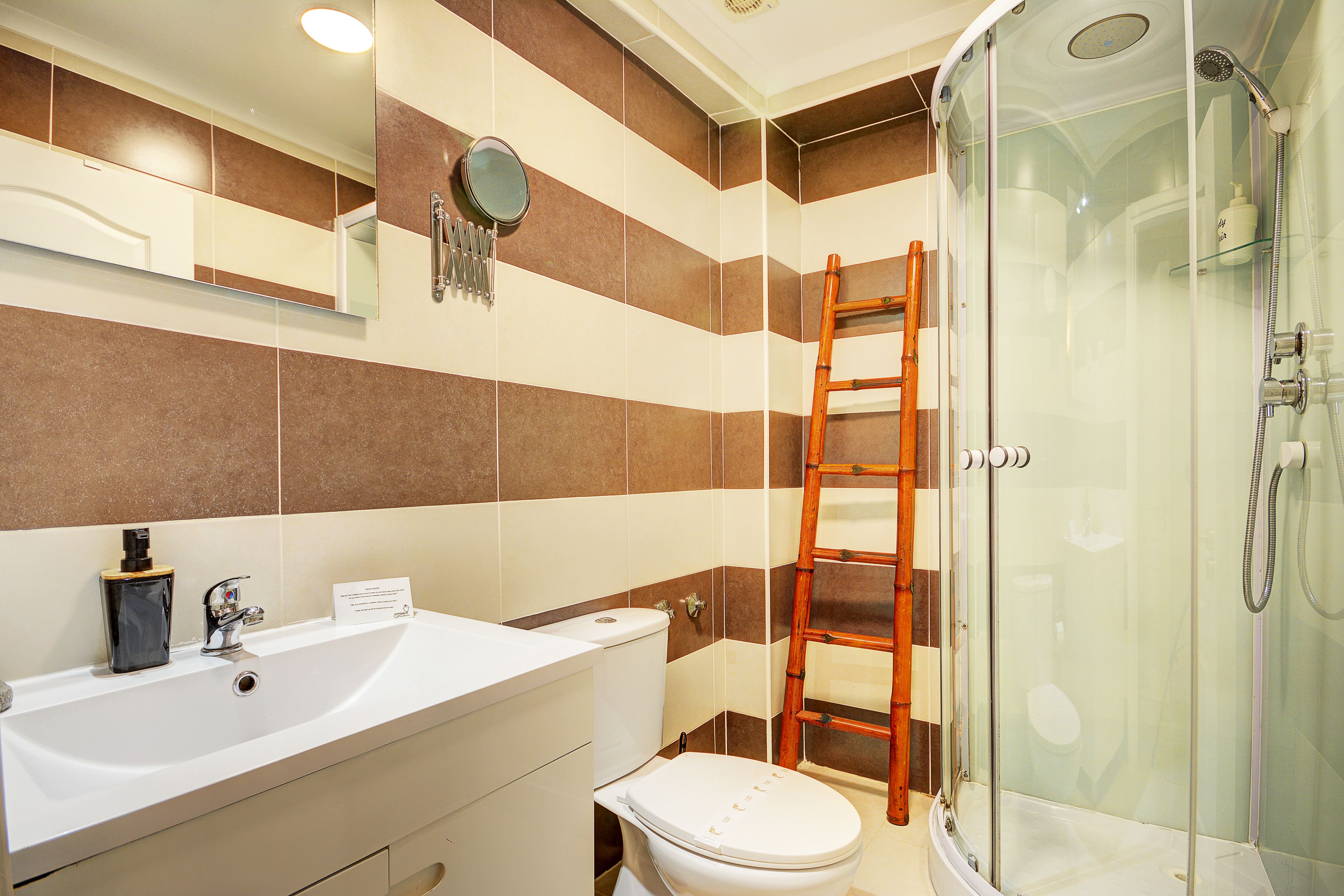 A bathroom with a bathtub, toilet, and a shower area.