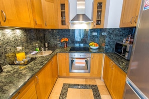 Deluxe Apartment, 1 Bedroom (Orange) | Private kitchen | Full-size fridge, microwave, oven, stovetop