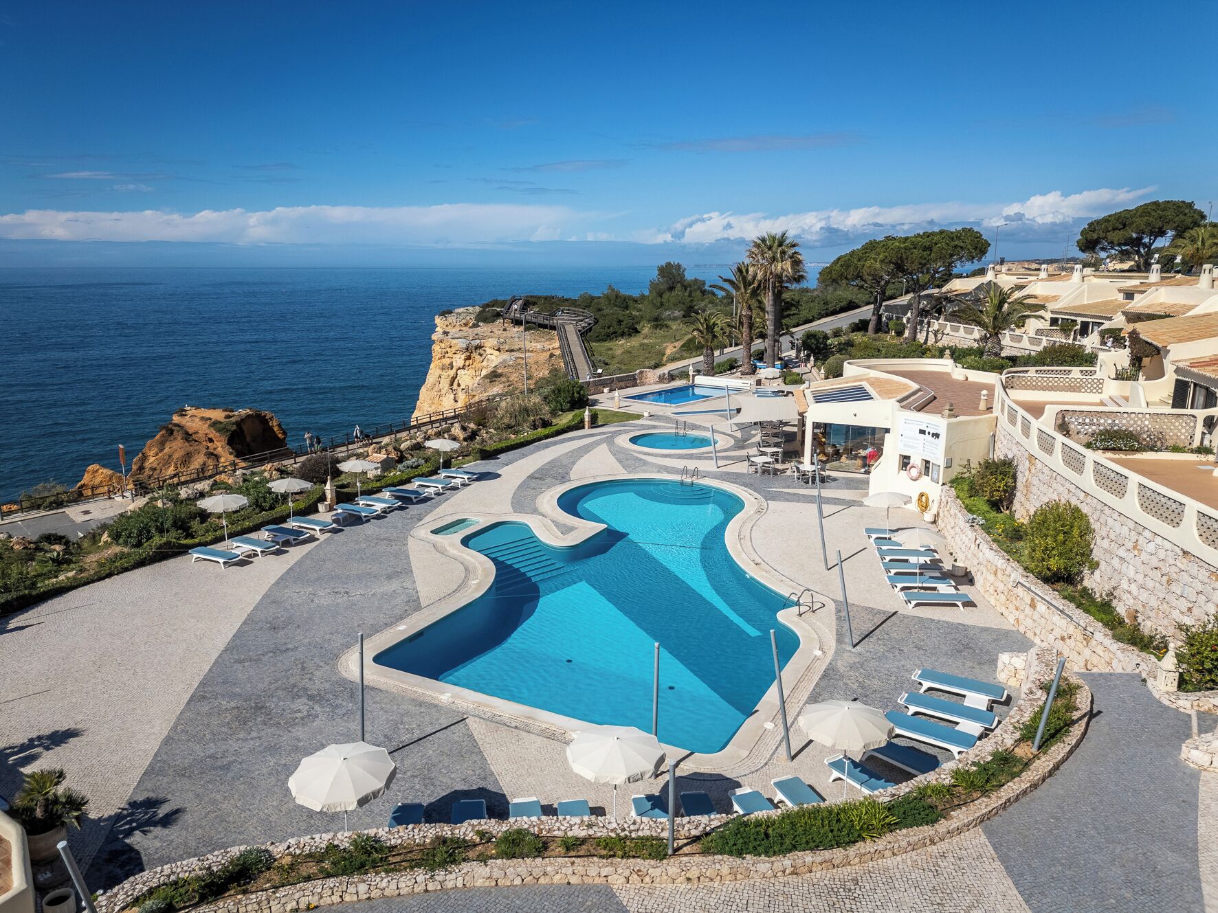 2 outdoor pools, open 9 AM to 7 PM, pool umbrellas, pool loungers