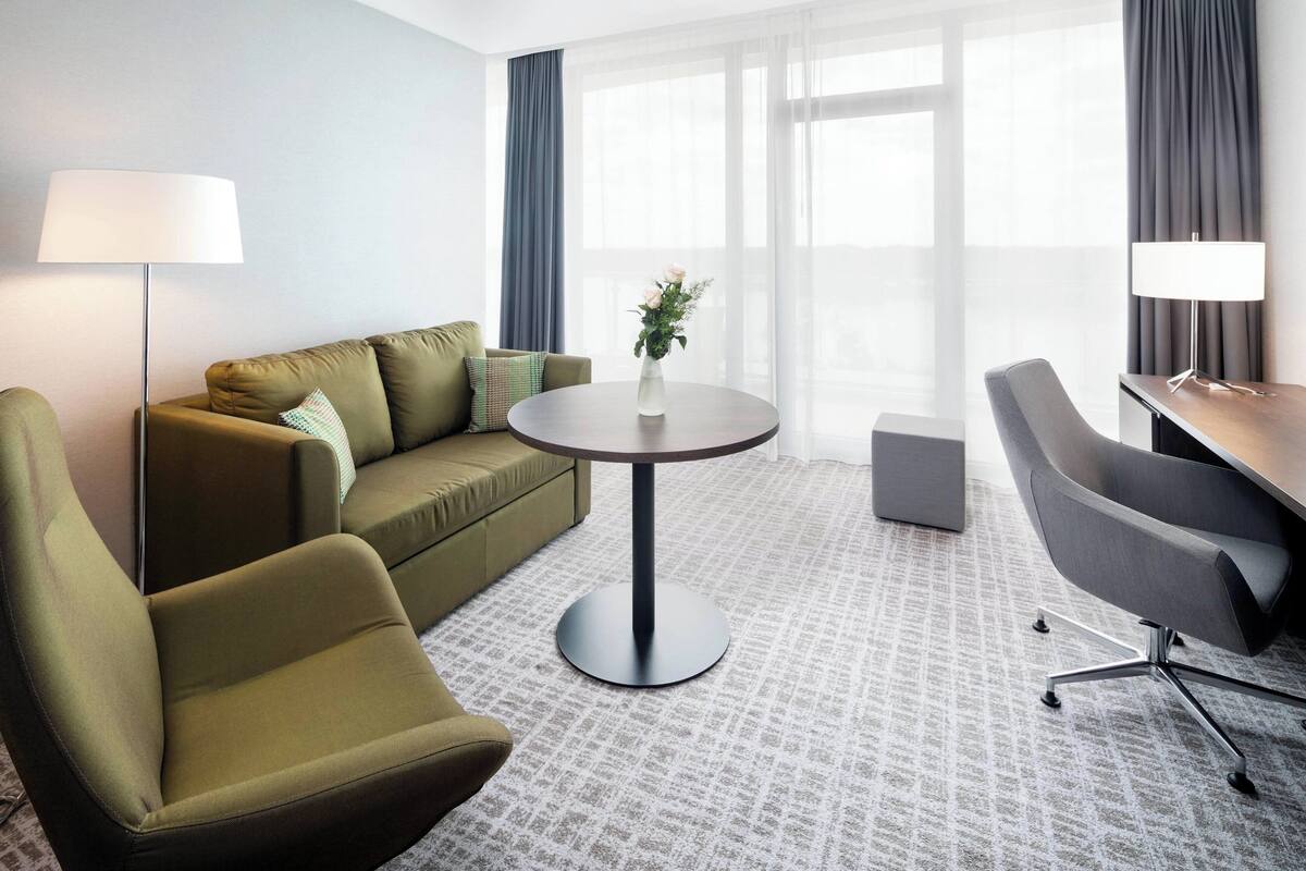 suite, 1 king bed, non smoking, lake view (balcony) | living area | lcd tv, pay films