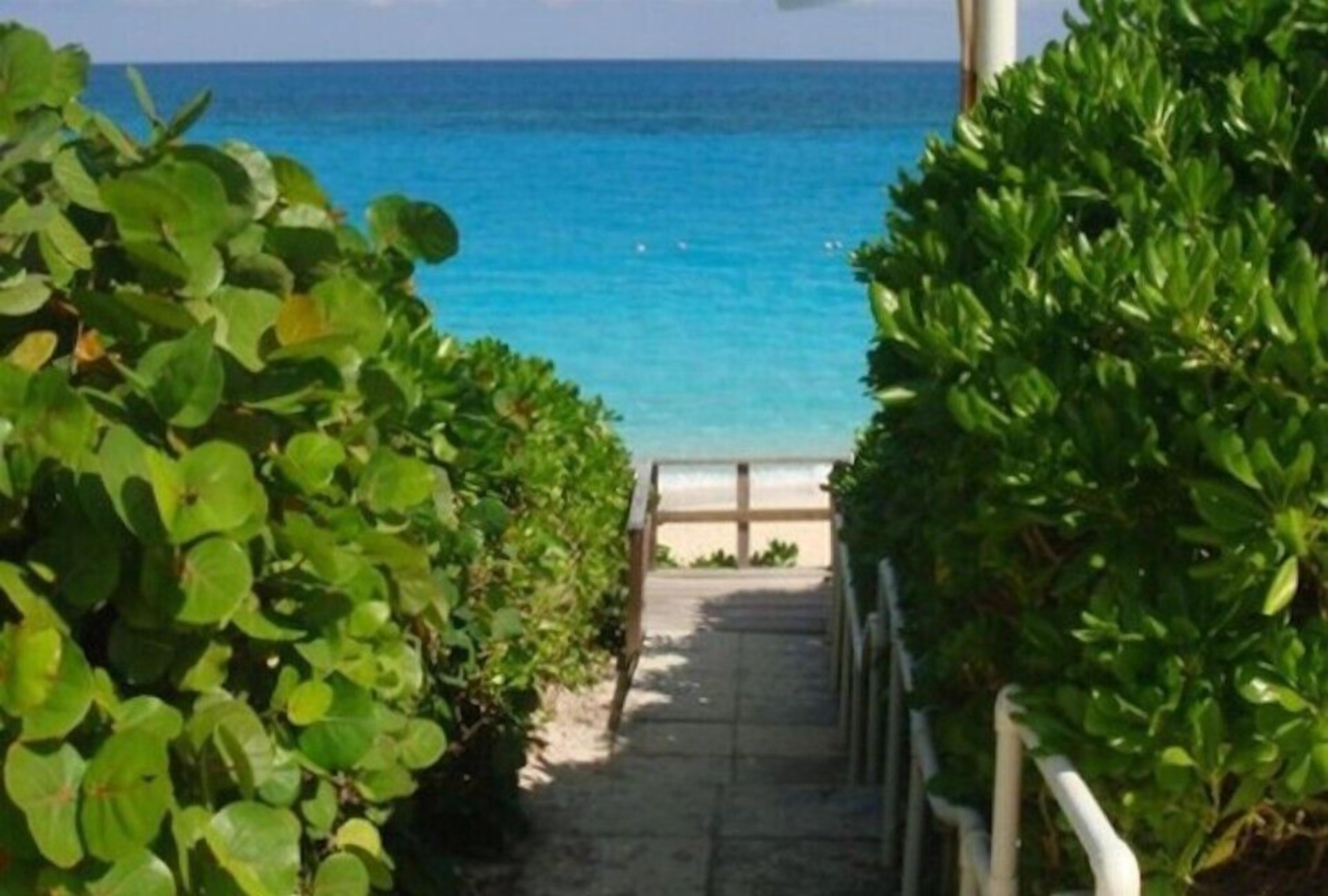 On the beach, white sand, sun loungers, beach towels