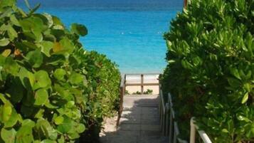 On the beach, white sand, sun loungers, beach towels