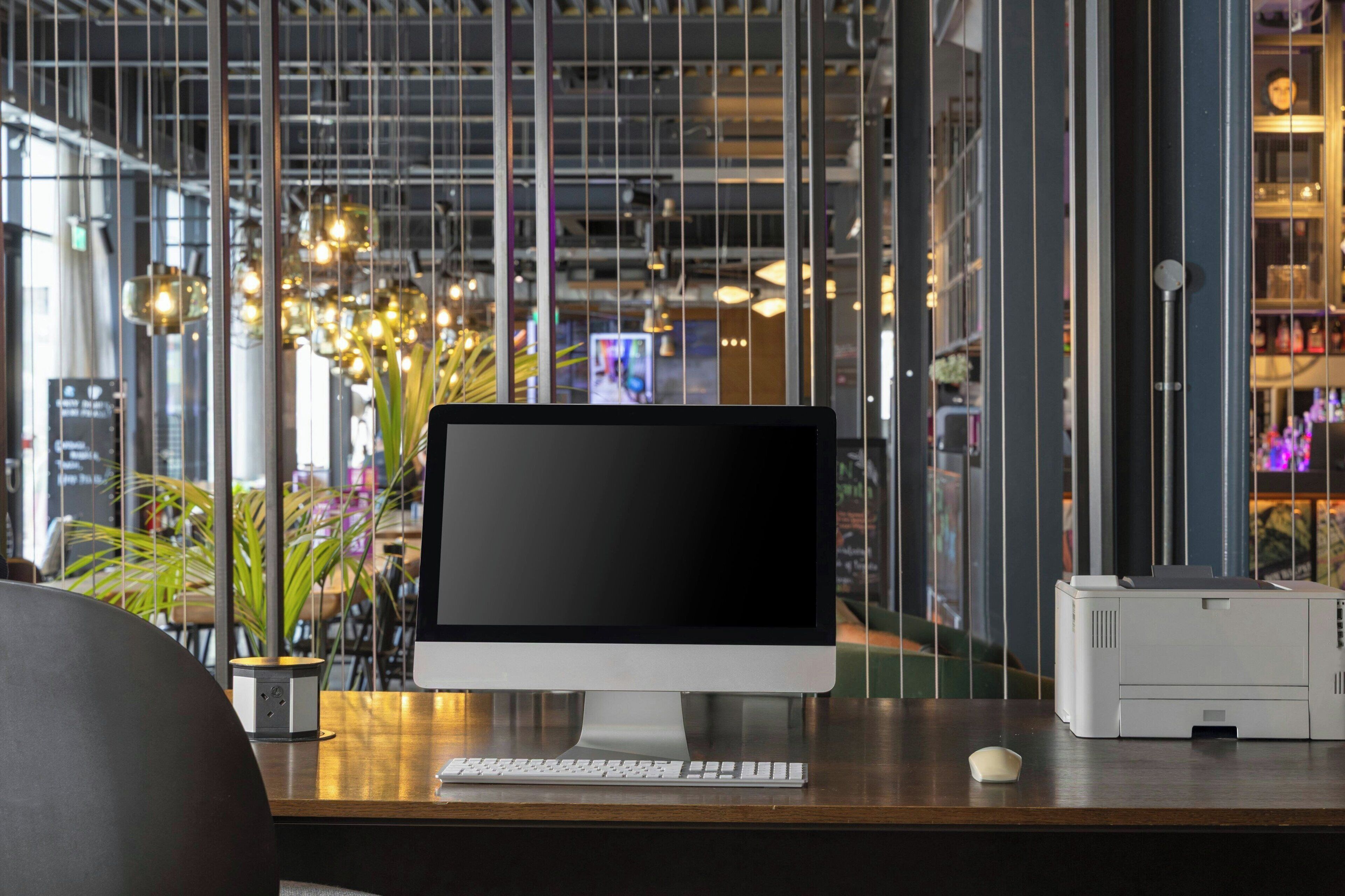 A modern office desk with a desktop computer, keyboard, and mouse.