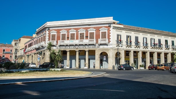 A historic building with a central courtyard, columns, and balconies.
