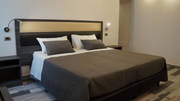 Family Triple Room | Minibar (free items), in-room safe, desk, soundproofing
