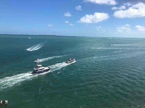 A view of the ocean with several boats on the water.