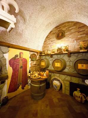 A room with a stone fireplace, wooden barrel, and a mural of a historical figure. - Villa with enchanting view of the lake, private swimming pool and whirlpool (Montefiascone)